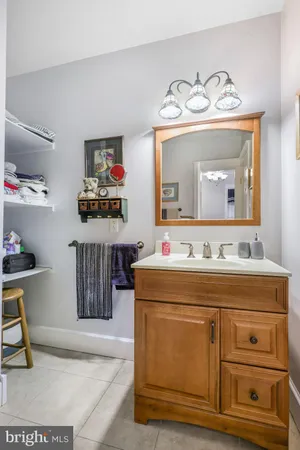 a bathroom with a sink a toilet and a mirror