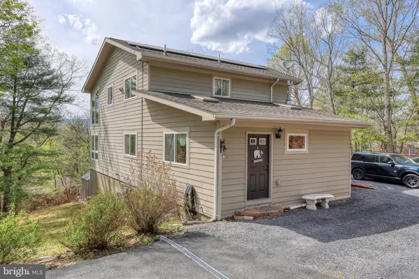 a large kitchen with stainless steel appliances granite countertop a refrigerator a sink dishwasher a stove and white countertops with wooden floor