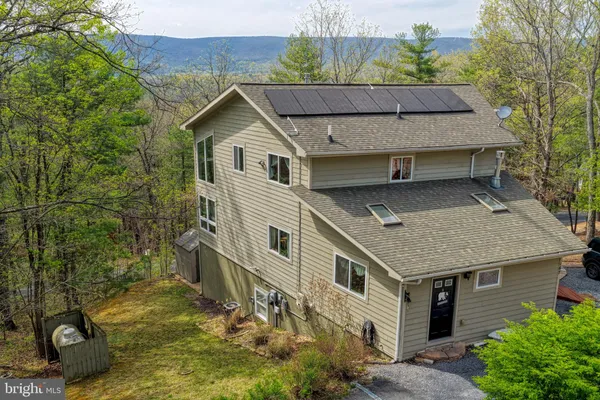 a kitchen with stainless steel appliances granite countertop a refrigerator a sink dishwasher a stove and white cabinets with wooden floor