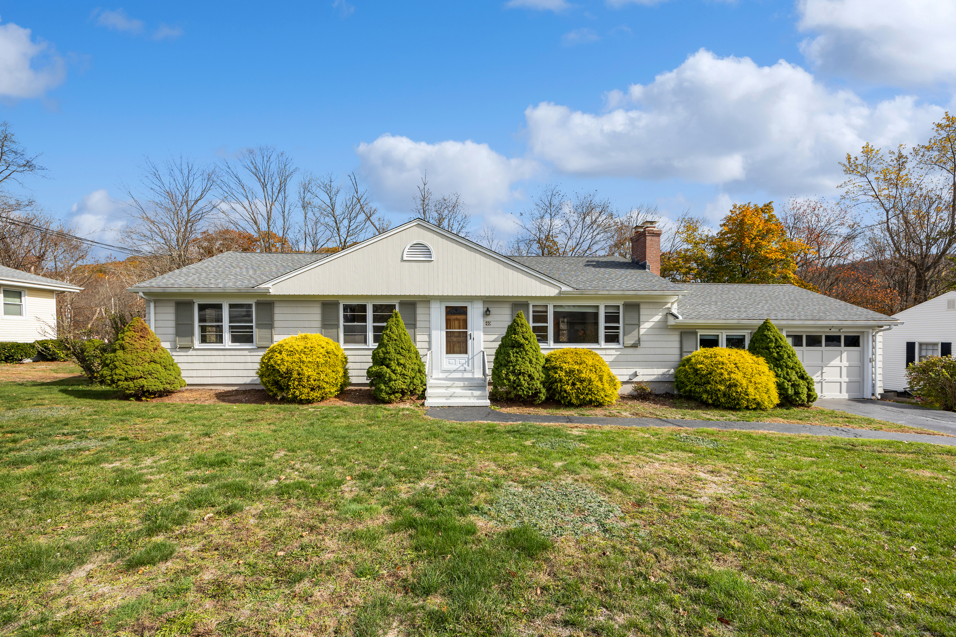 a front view of a house with garden and porch