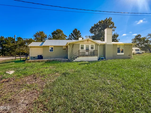a view of kitchen with refrigerator stove and cabinets