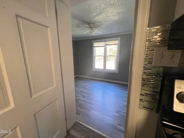 a spacious bedroom with a bed and a flat screen tv