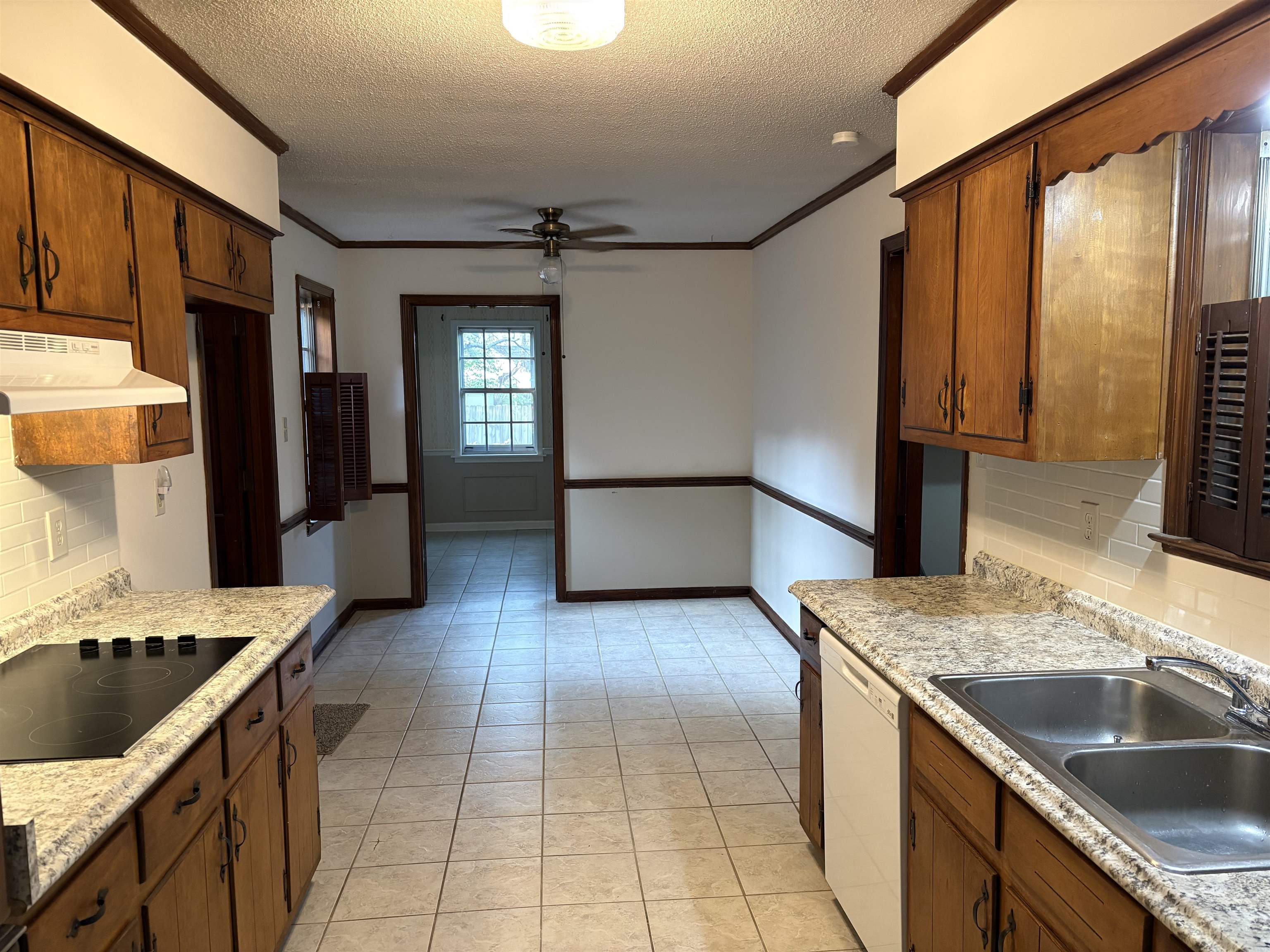 5459 Knight Arnold Road Memphis, TN 38115 - Photo 16 of 38 Kitchen featuring backsplash, ceiling fan, crown molding, black electric cooktop, and dishwasher