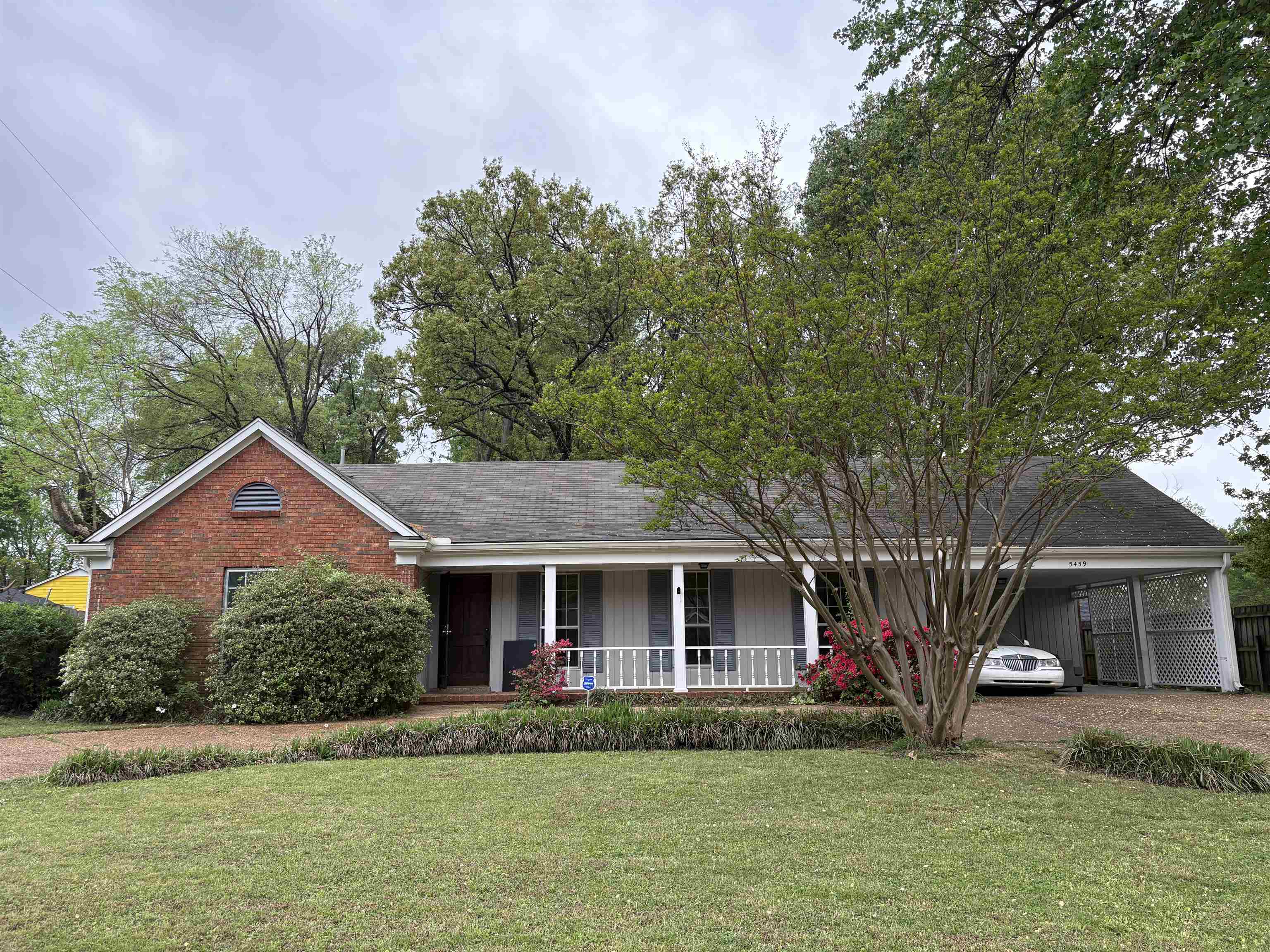 5459 Knight Arnold Road Memphis, TN 38115 - Photo 2 of 38 Ranch-style house featuring a front lawn, a porch, driveway, and roof with shingles