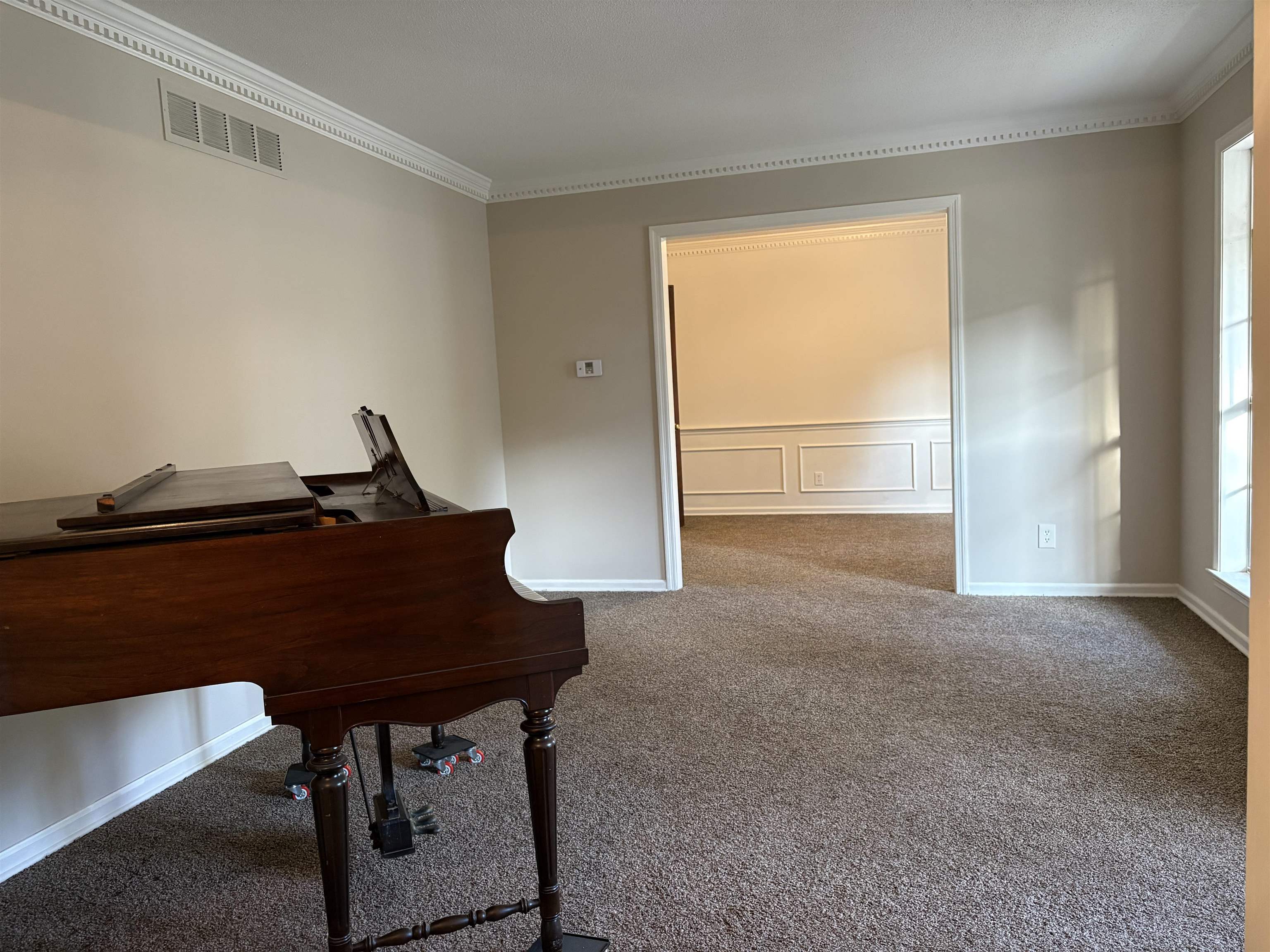 5459 Knight Arnold Road Memphis, TN 38115 - Photo 8 of 38 Carpeted home office featuring ornamental molding, a decorative wall, and a wainscoted wall