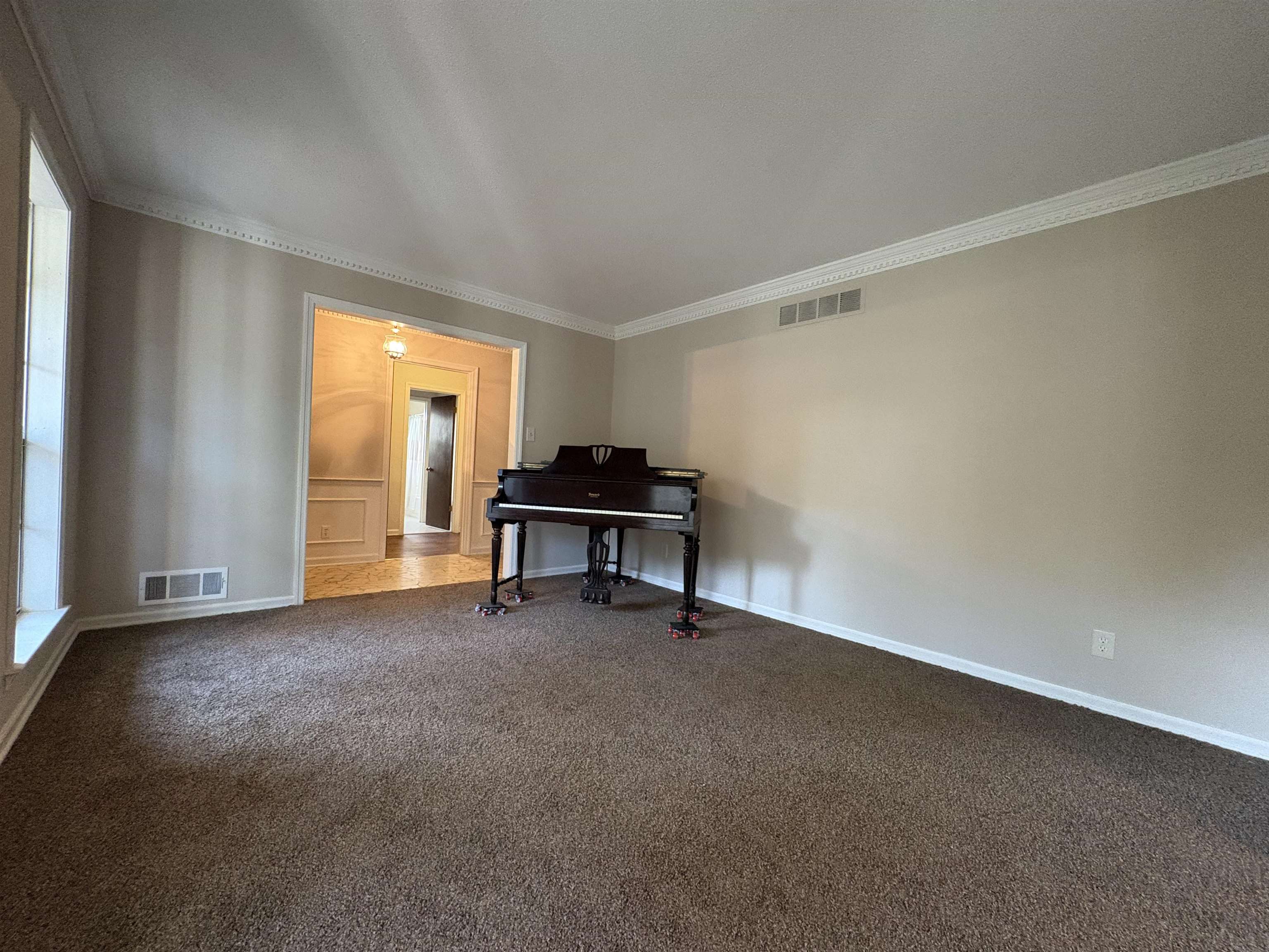5459 Knight Arnold Road Memphis, TN 38115 - Photo 9 of 38 Living area featuring dark carpet and ornamental molding