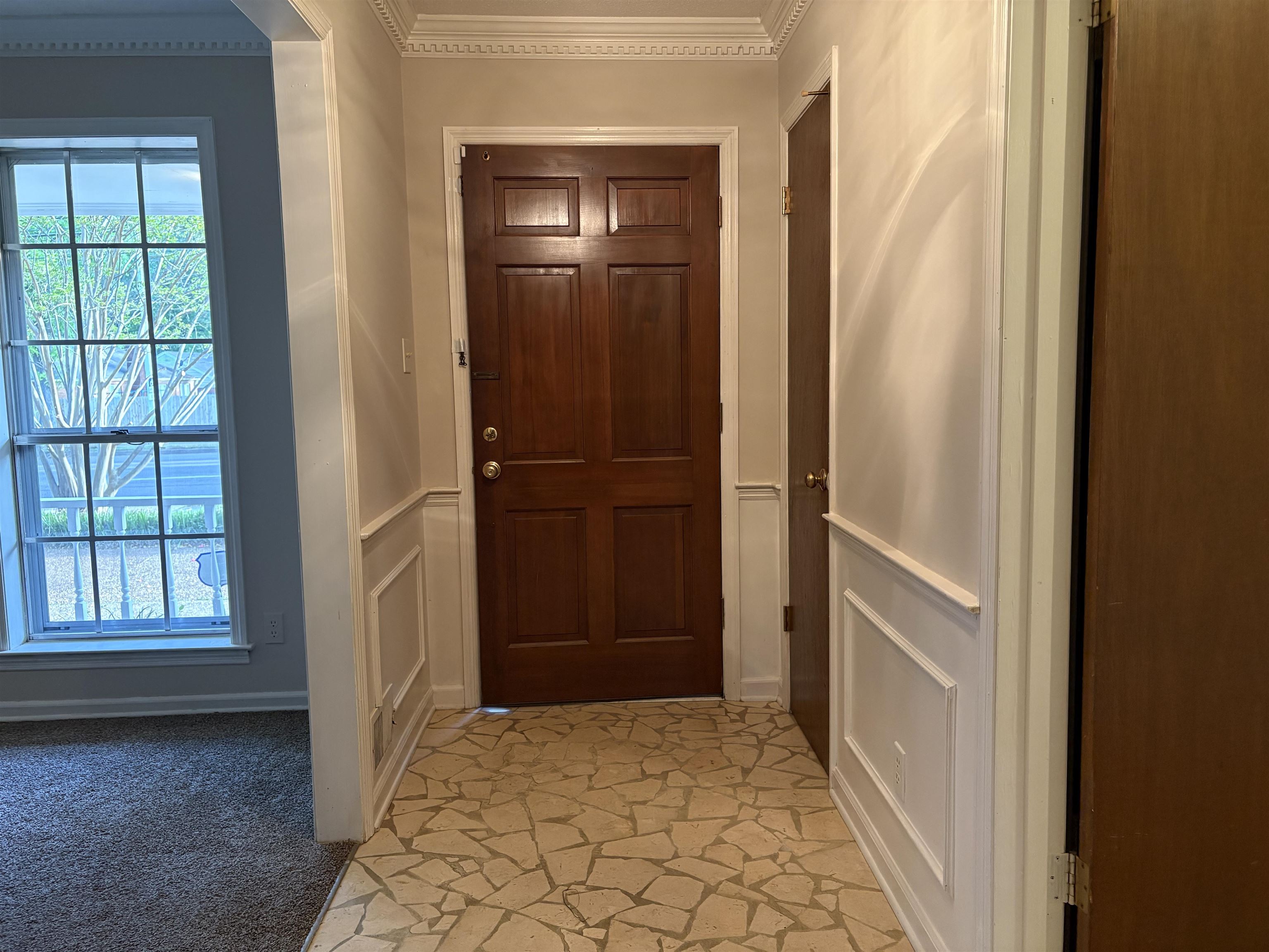 5459 Knight Arnold Road Memphis, TN 38115 - Photo 10 of 38 Doorway with crown molding and a decorative wall