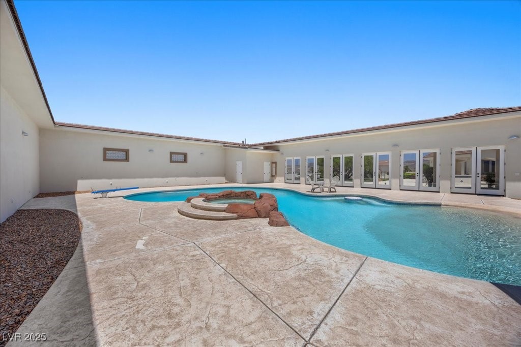 640 Quail Covey Road Henderson, NV 89002 - Photo 51 of 75 View of Pool House with swimming pool with a patio area, a pool with connected hot tub, and french doors and Bathroom And Shower