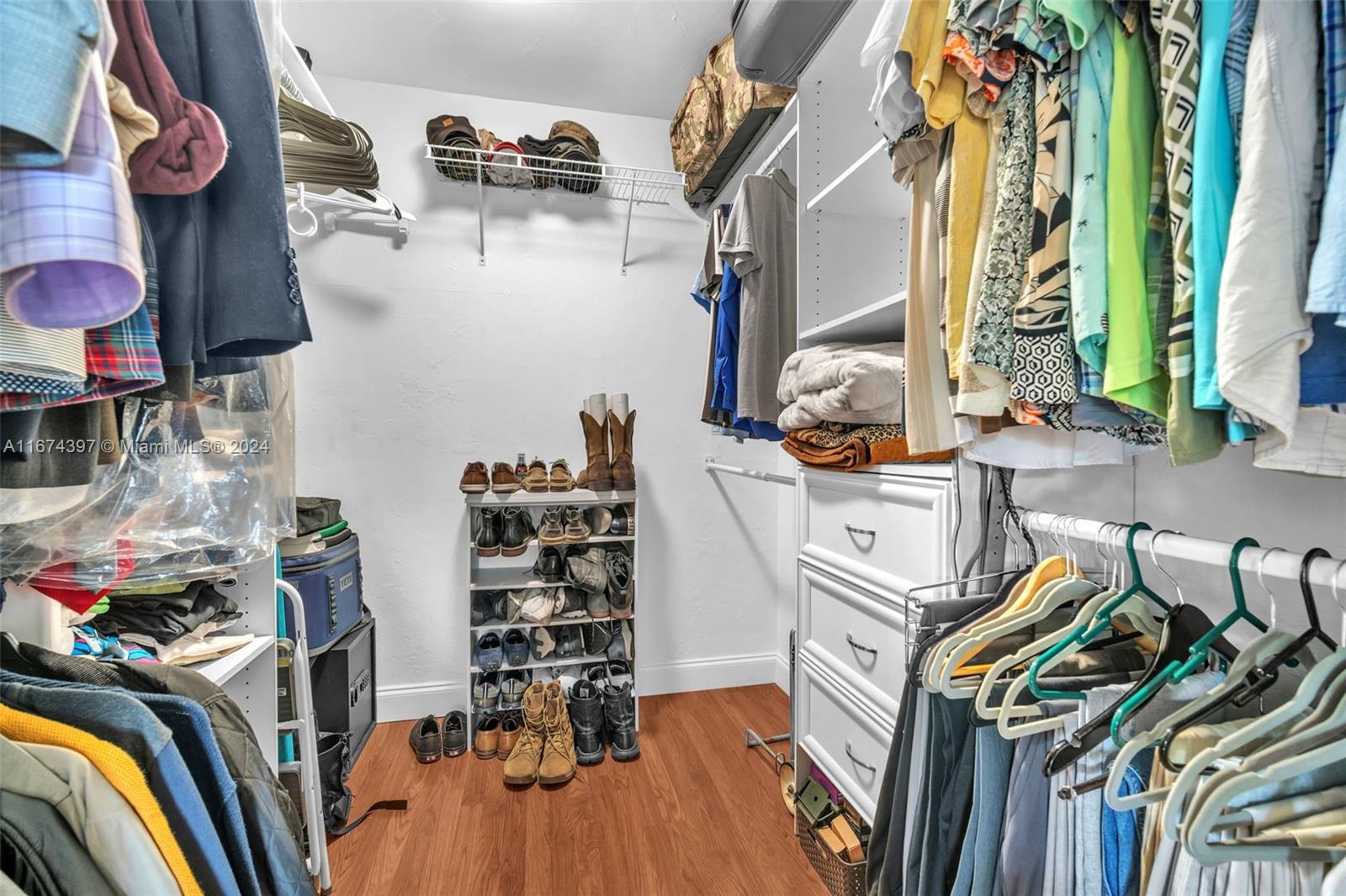 8335 Southwest 72nd Avenue, Unit 312D Miami, FL 33143 - Photo 13 of 45 a view of walk in closet with clothes and shoes