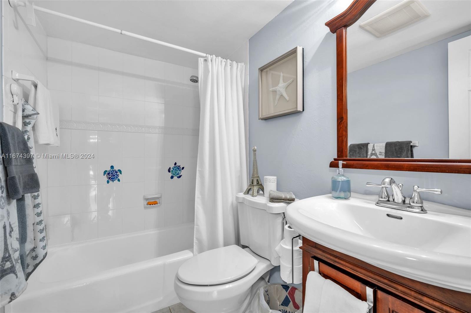 8335 Southwest 72nd Avenue, Unit 312D Miami, FL 33143 - Photo 14 of 45 a bathroom with a sink toilet and shower