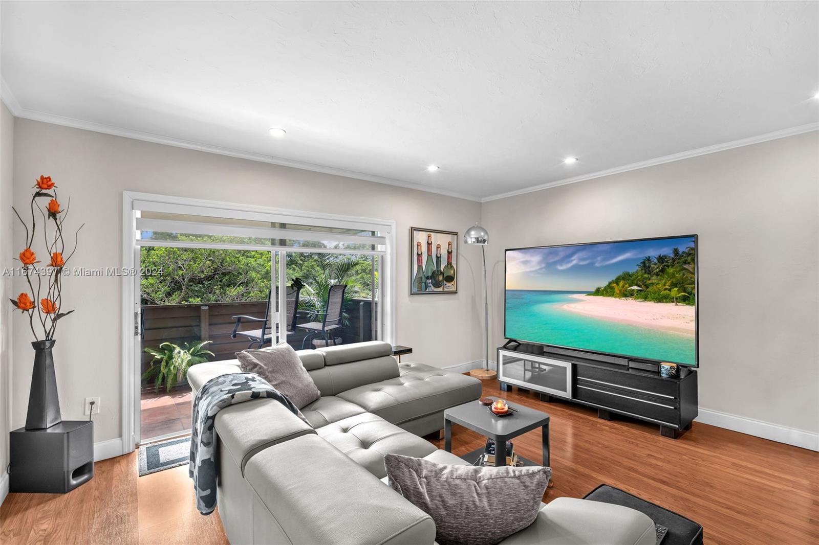 8335 Southwest 72nd Avenue, Unit 312D Miami, FL 33143 - Photo 17 of 45 a living room with furniture flat screen tv and a large window