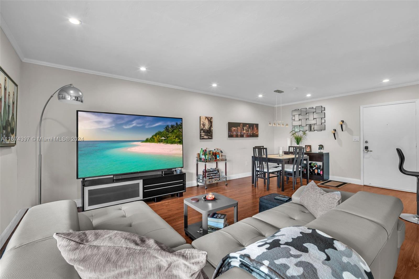8335 Southwest 72nd Avenue, Unit 312D Miami, FL 33143 - Photo 18 of 45 a living room with furniture and a flat screen tv
