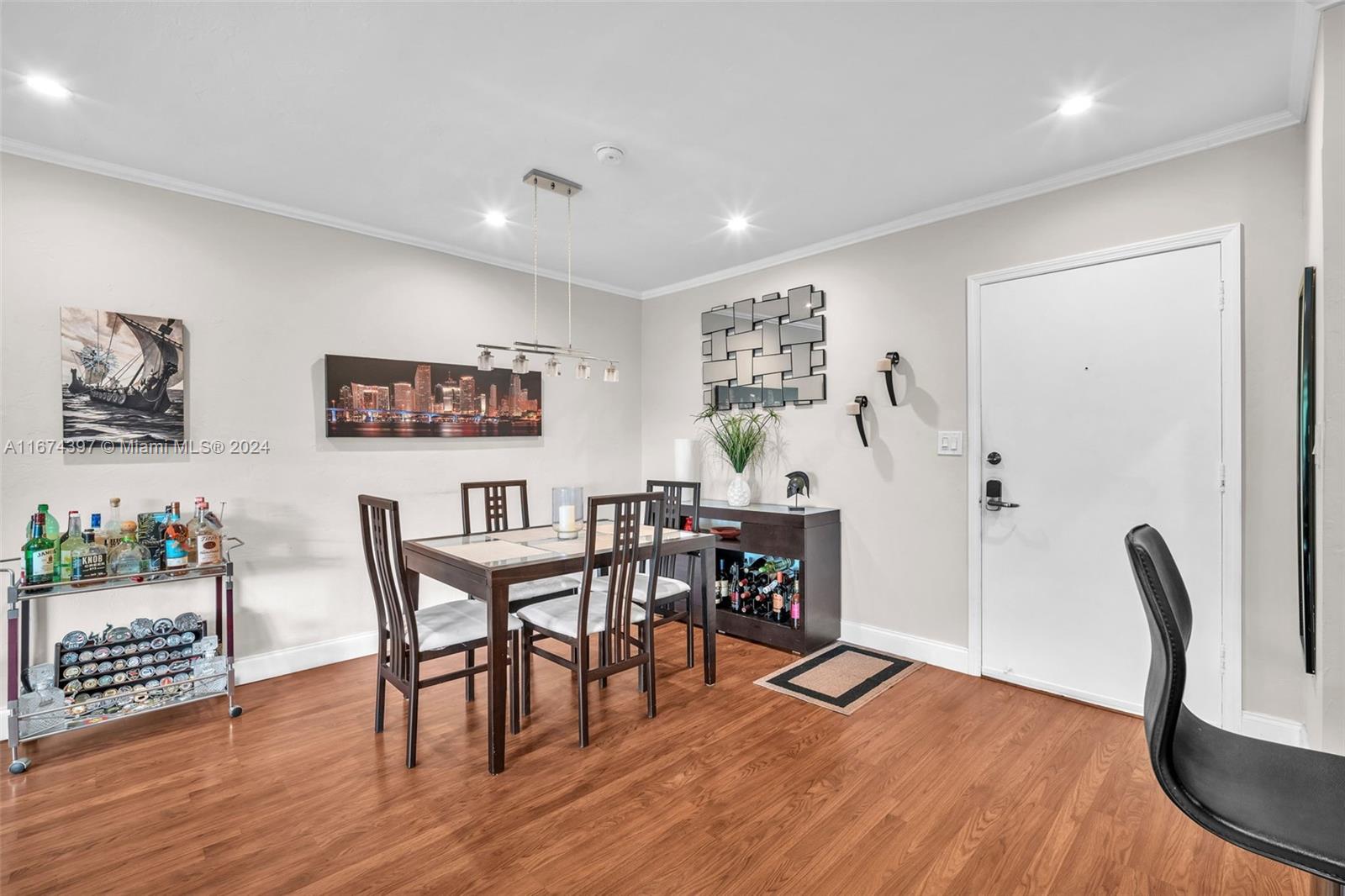 8335 Southwest 72nd Avenue, Unit 312D Miami, FL 33143 - Photo 19 of 45 a view of a dining room with furniture and wooden floor