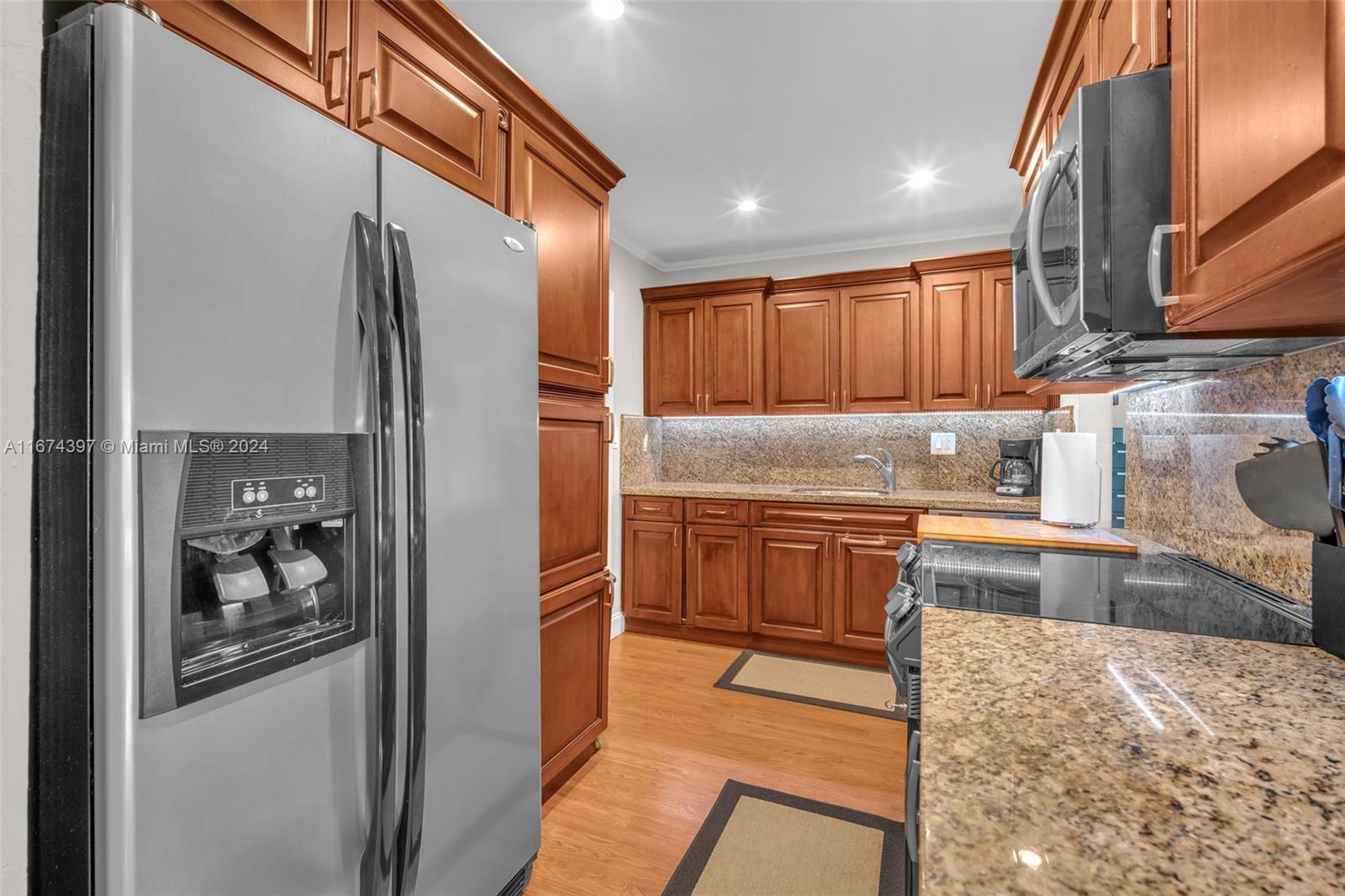 8335 Southwest 72nd Avenue, Unit 312D Miami, FL 33143 - Photo 20 of 45 a kitchen with stainless steel appliances granite countertop a refrigerator and a sink