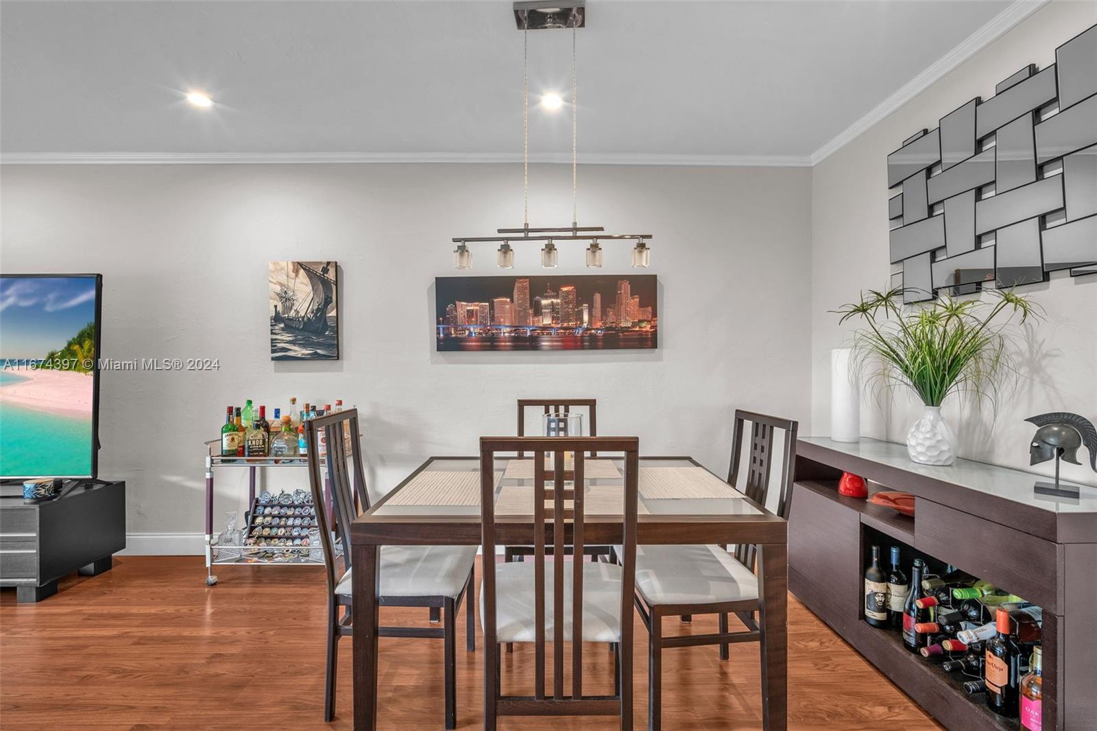 8335 Southwest 72nd Avenue, Unit 312D Miami, FL 33143 - Photo 2 of 45 a view of a dining room with furniture and wooden floor