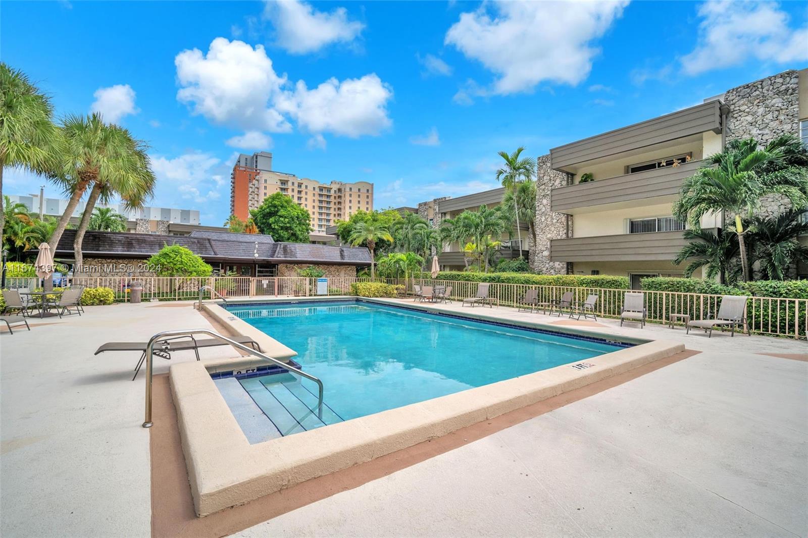8335 Southwest 72nd Avenue, Unit 312D Miami, FL 33143 - Photo 22 of 45 a view of a swimming pool with a patio and a yard