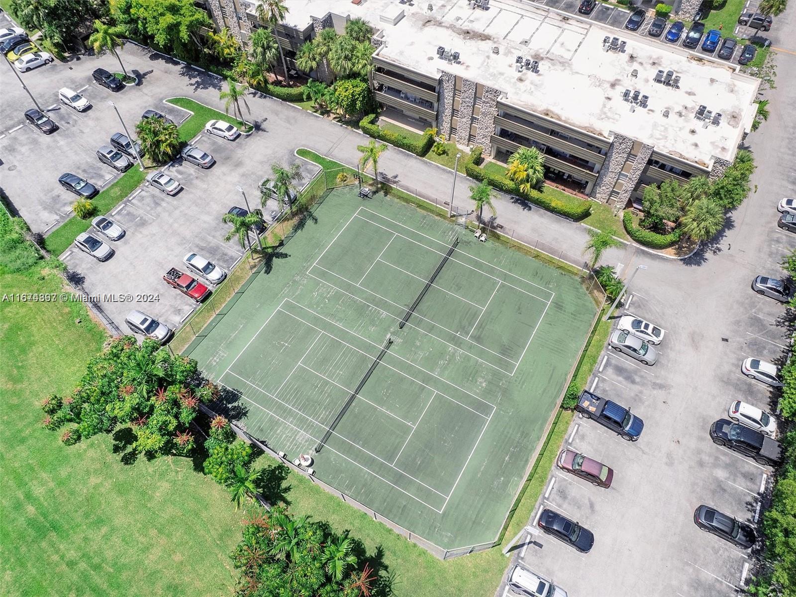 8335 Southwest 72nd Avenue, Unit 312D Miami, FL 33143 - Photo 29 of 45 an aerial view of a tennis ground with large trees