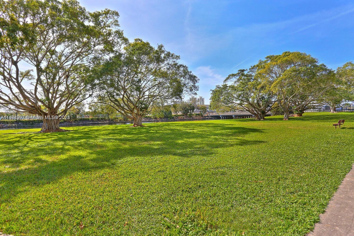 8335 Southwest 72nd Avenue, Unit 312D Miami, FL 33143 - Photo 31 of 45 a view of a big yard with plants and large trees