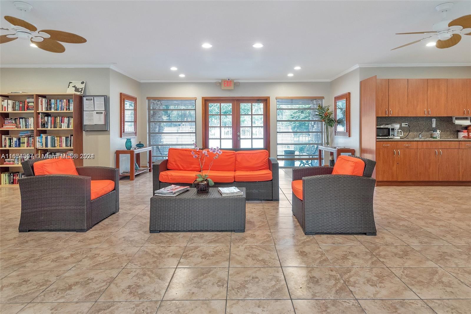 8335 Southwest 72nd Avenue, Unit 312D Miami, FL 33143 - Photo 32 of 45 a living room with furniture and a floor to ceiling window