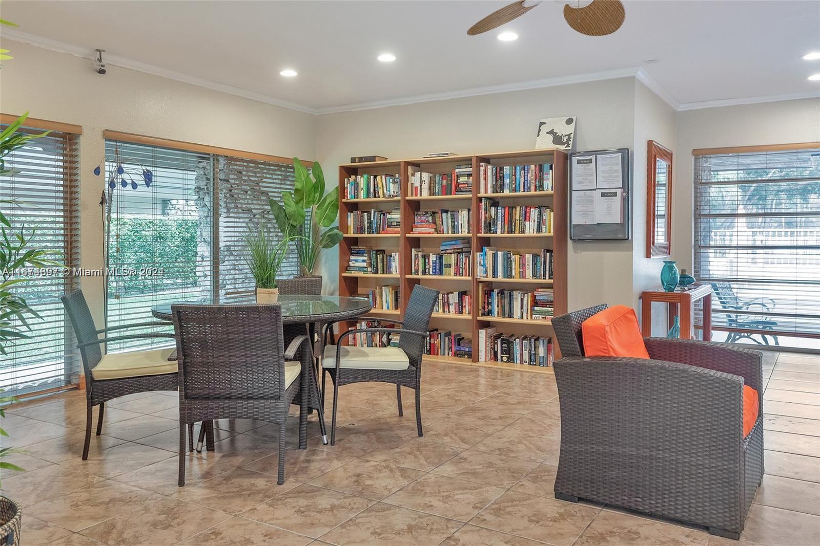8335 Southwest 72nd Avenue, Unit 312D Miami, FL 33143 - Photo 33 of 45 a dining room with furniture and a book shelf