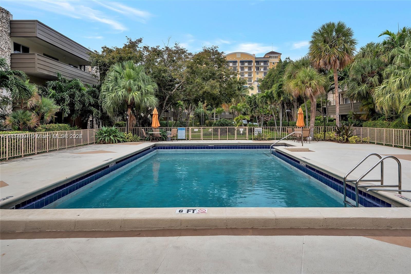 8335 Southwest 72nd Avenue, Unit 312D Miami, FL 33143 - Photo 38 of 45 a view of a terrace with a bench