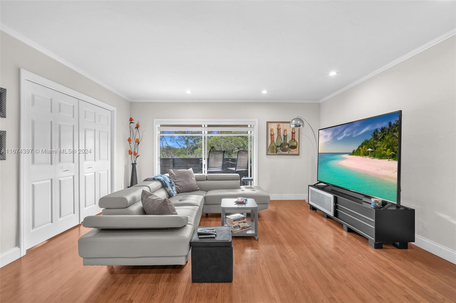8335 Southwest 72nd Avenue, Unit 312D Miami, FL 33143 - Photo 5 of 45 a living room with furniture and a flat screen tv