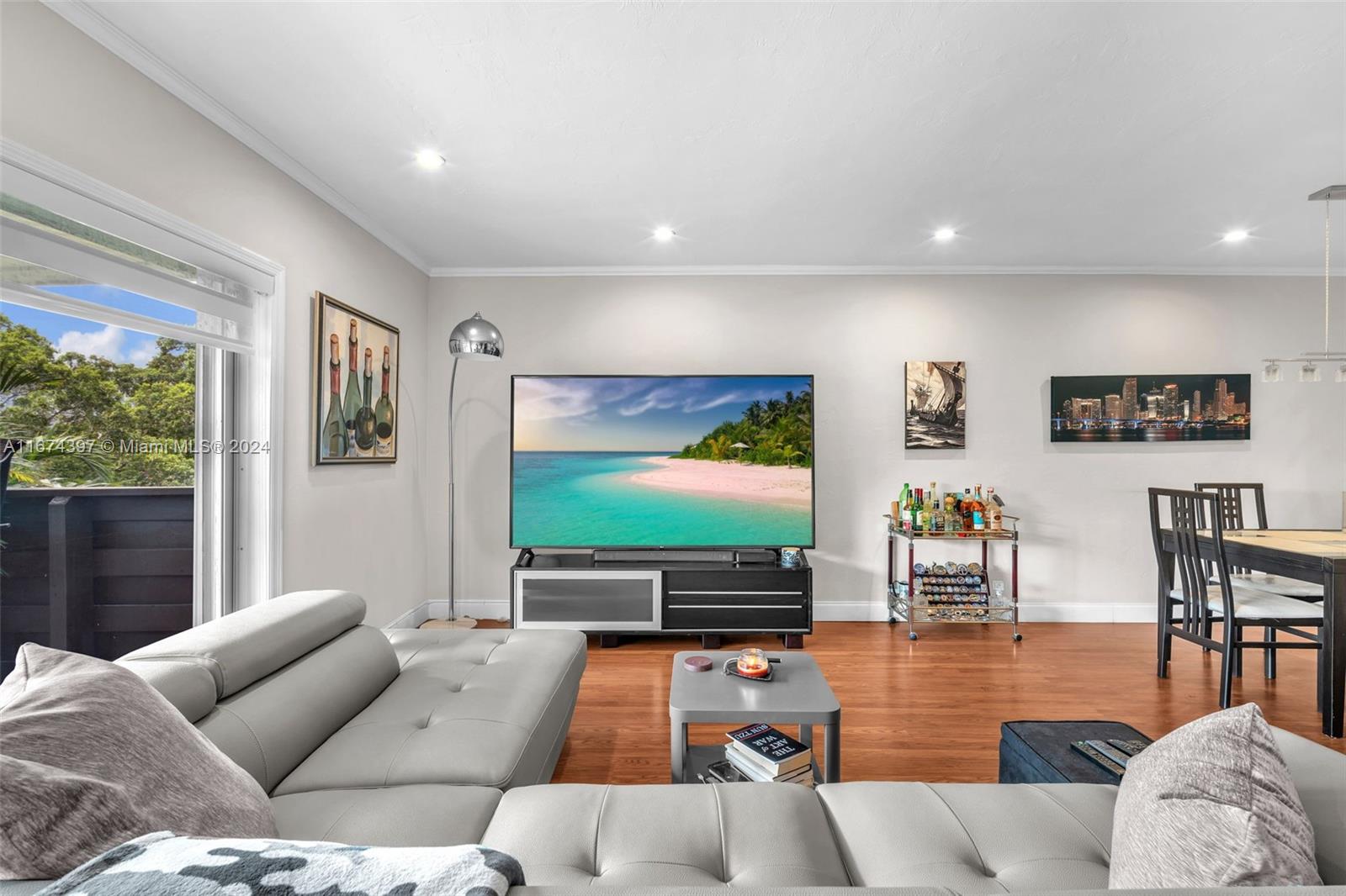 8335 Southwest 72nd Avenue, Unit 312D Miami, FL 33143 - Photo 6 of 45 a living room with furniture and a flat screen tv