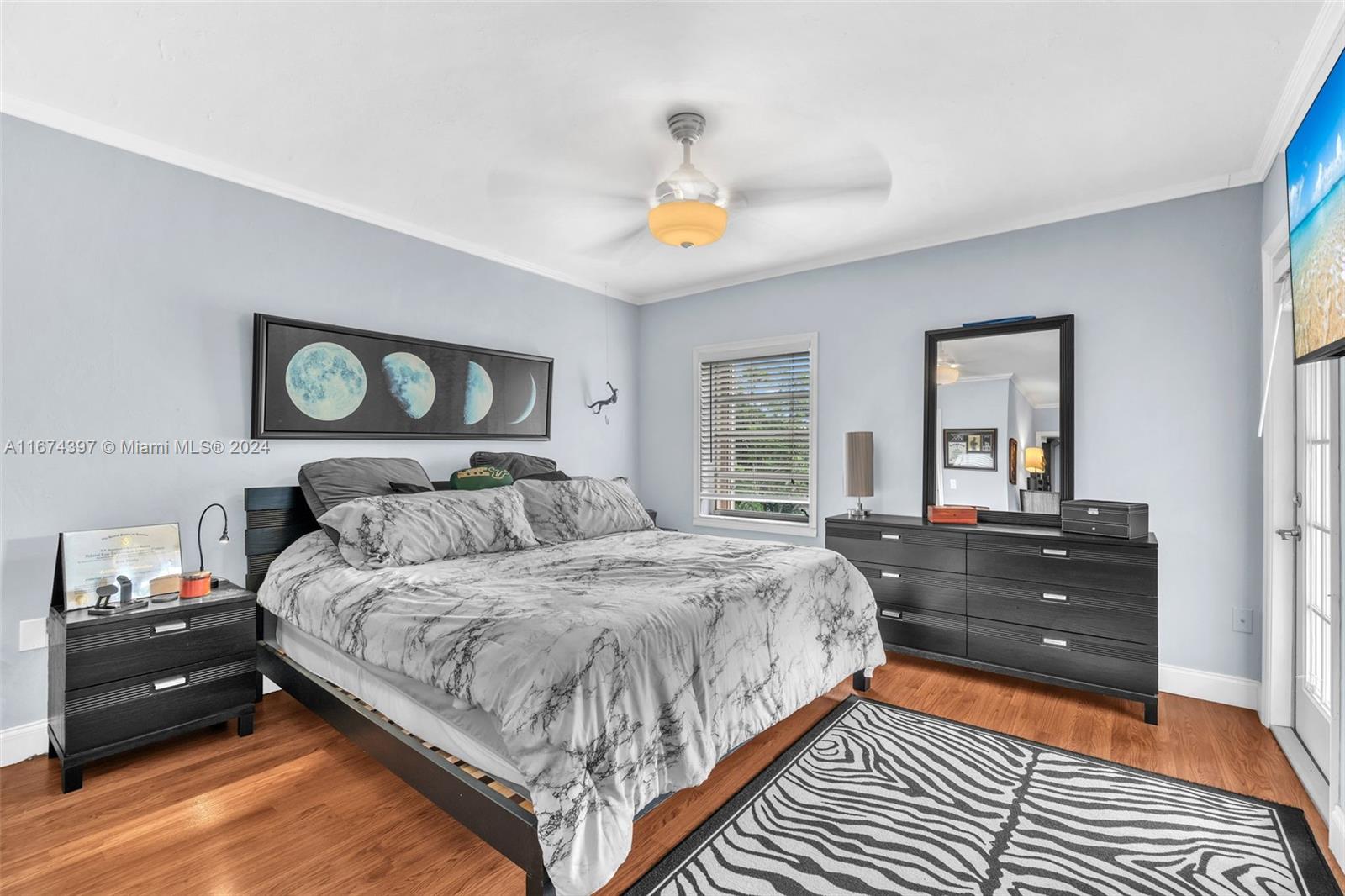 8335 Southwest 72nd Avenue, Unit 312D Miami, FL 33143 - Photo 7 of 45 a bedroom with a bed and wooden floor