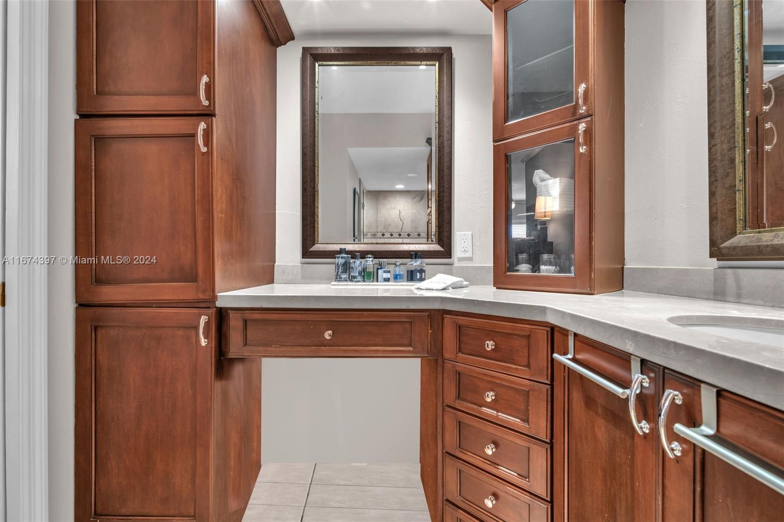 8335 Southwest 72nd Avenue, Unit 312D Miami, FL 33143 - Photo 10 of 45 a bathroom with a sink and a mirror