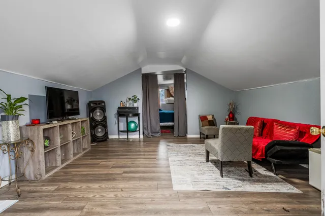 a view of a backyard with table and chairs under an umbrella