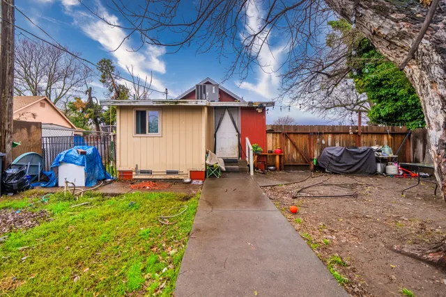 a view of backyard with swimming pool and outdoor seating