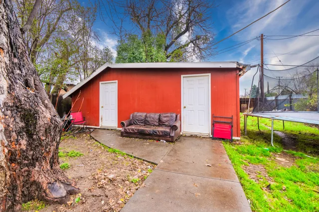 a backyard of a house with yard fire pit and outdoor seating