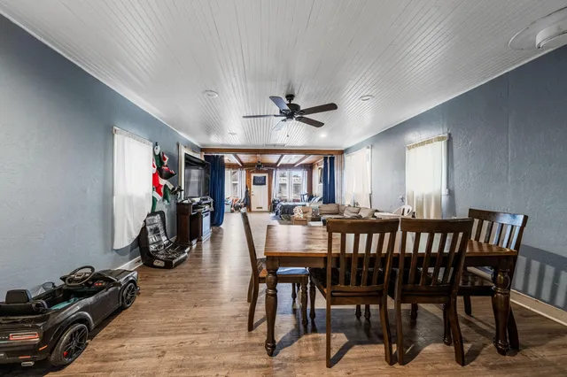 a view of a dining room with furniture and a chandelier