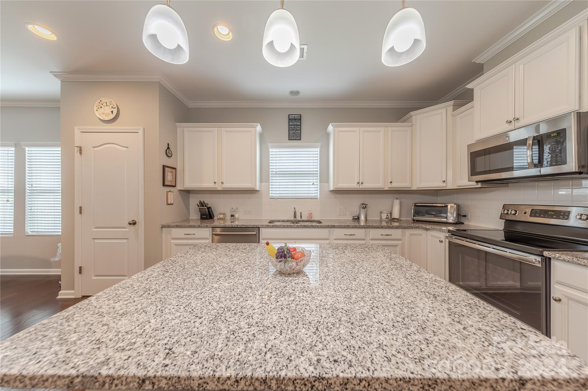 5824 Eleanor Rigby Road Charlotte, NC 28278 - Photo 8 of 34 a kitchen with a refrigerator and a stove top oven