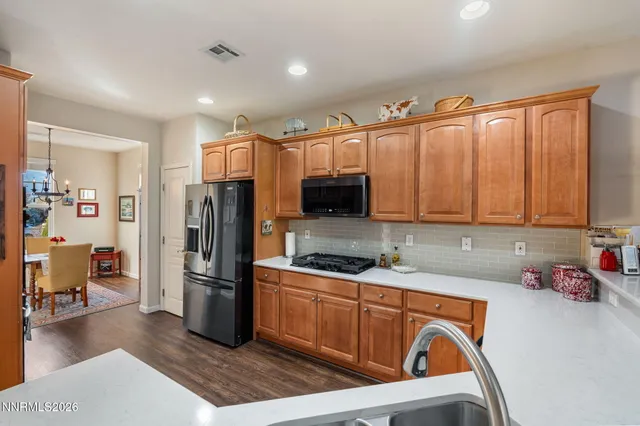 a kitchen with stainless steel appliances granite countertop a refrigerator sink and cabinets