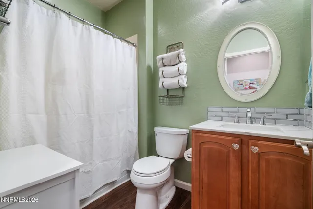 a bathroom with a toilet a sink and a mirror