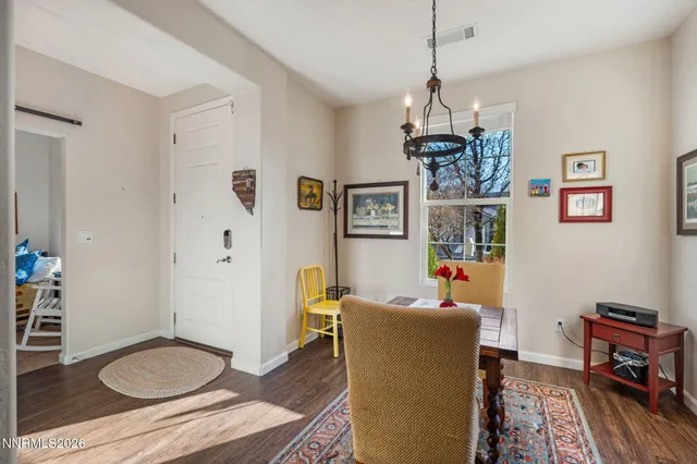 a living room with furniture a dining table and a chandelier