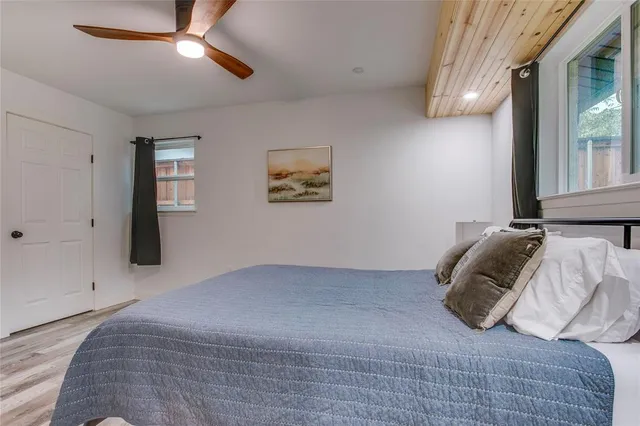 a bedroom with a bed and a window