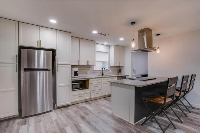 a kitchen with appliances cabinets and a counter top space