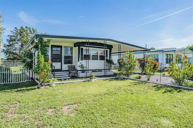 a view of a house with backyard porch and sitting area