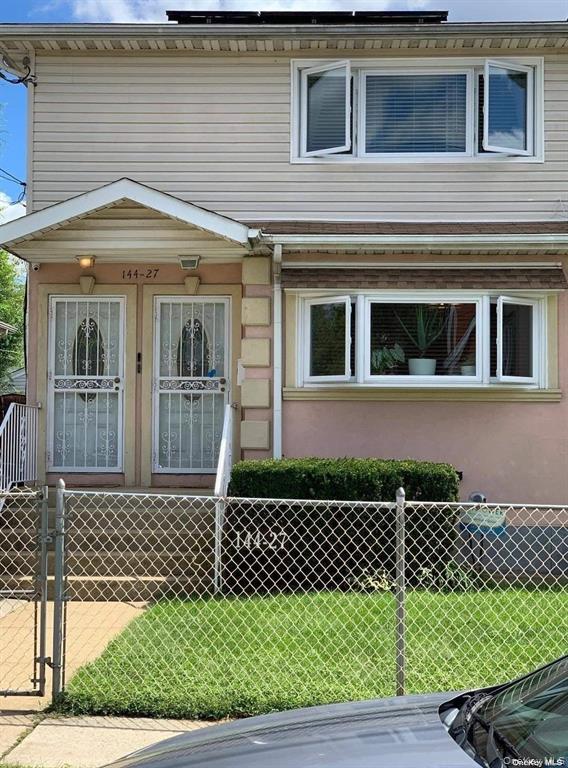 144-27 229th Street, Unit 2 Queens, NY 11413 - Photo 1 of 1 View of front of house with a gate