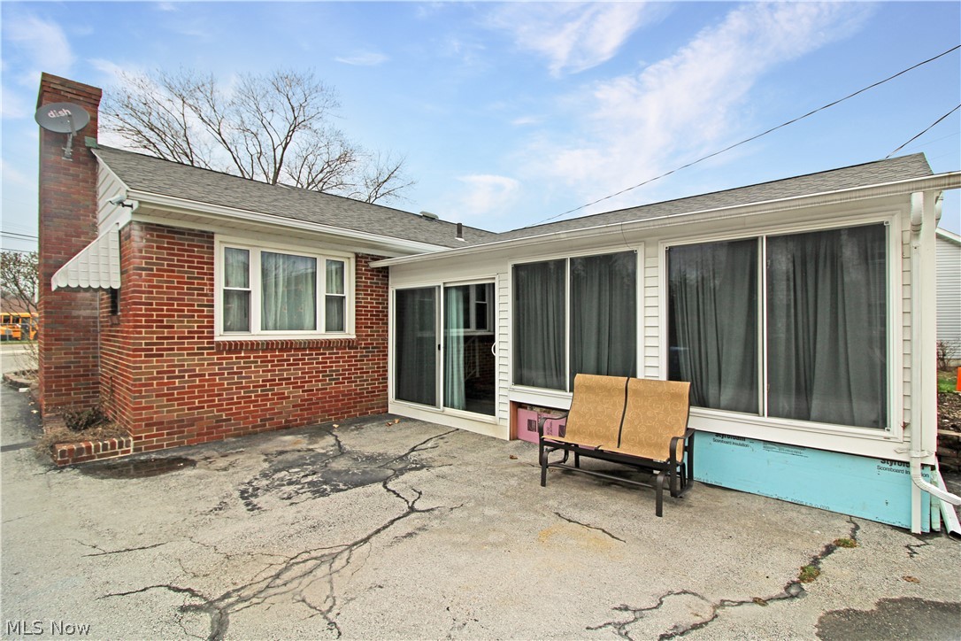 1036 West Fremont Road Port Clinton, OH 43452 - Photo 32 of 32 Rear view of property featuring a sunroom and a patio