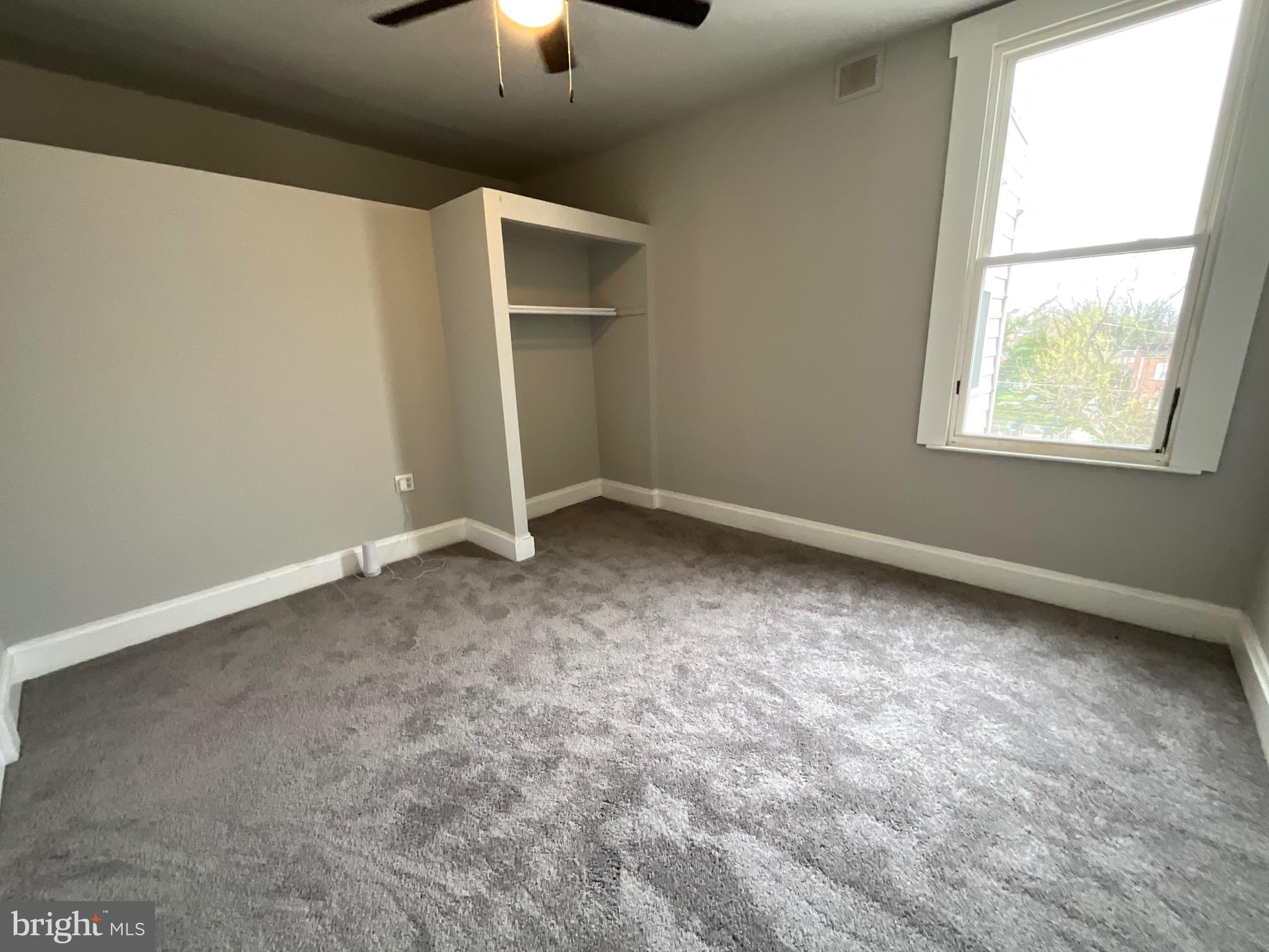 4415 Pimlico Road Baltimore, MD 21215 - Photo 11 of 18 an empty room with a empty space and a window