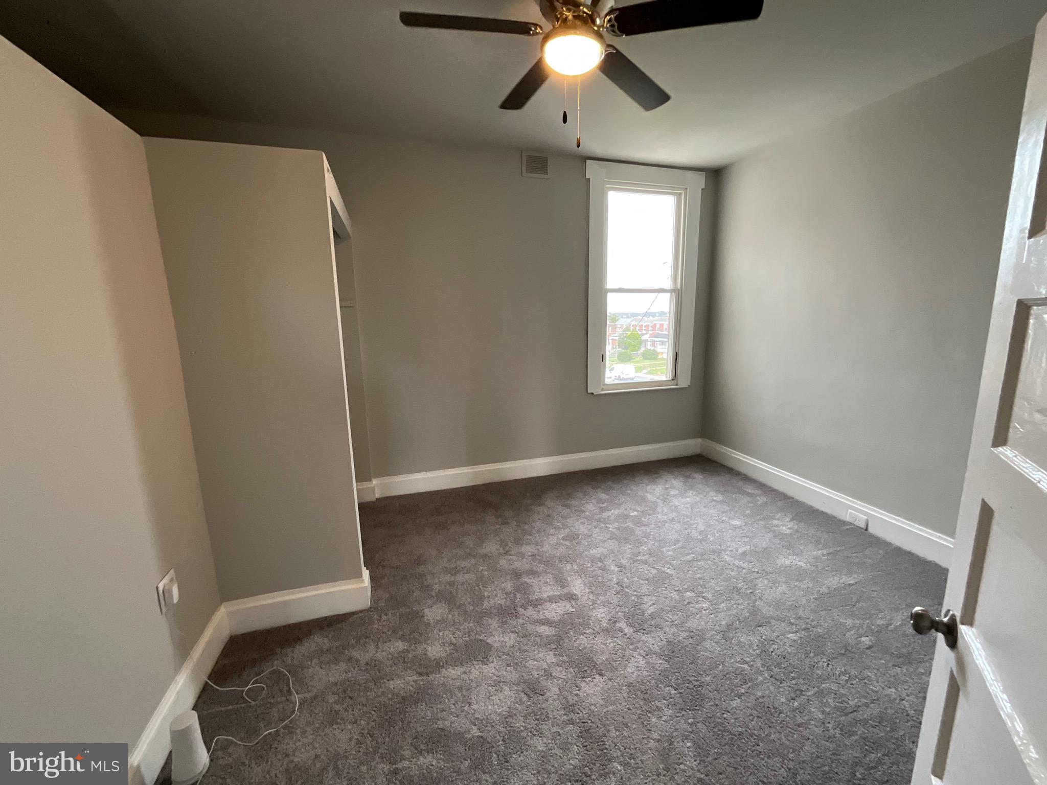 4415 Pimlico Road Baltimore, MD 21215 - Photo 10 of 18 a view of an empty room with a window