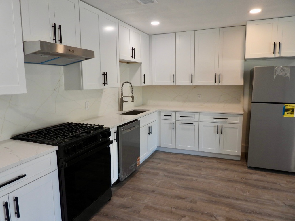 1619 Rutland Drive, Unit A Austin, TX 78758 - Photo 1 of 14 a kitchen with a stove sink and refrigerator