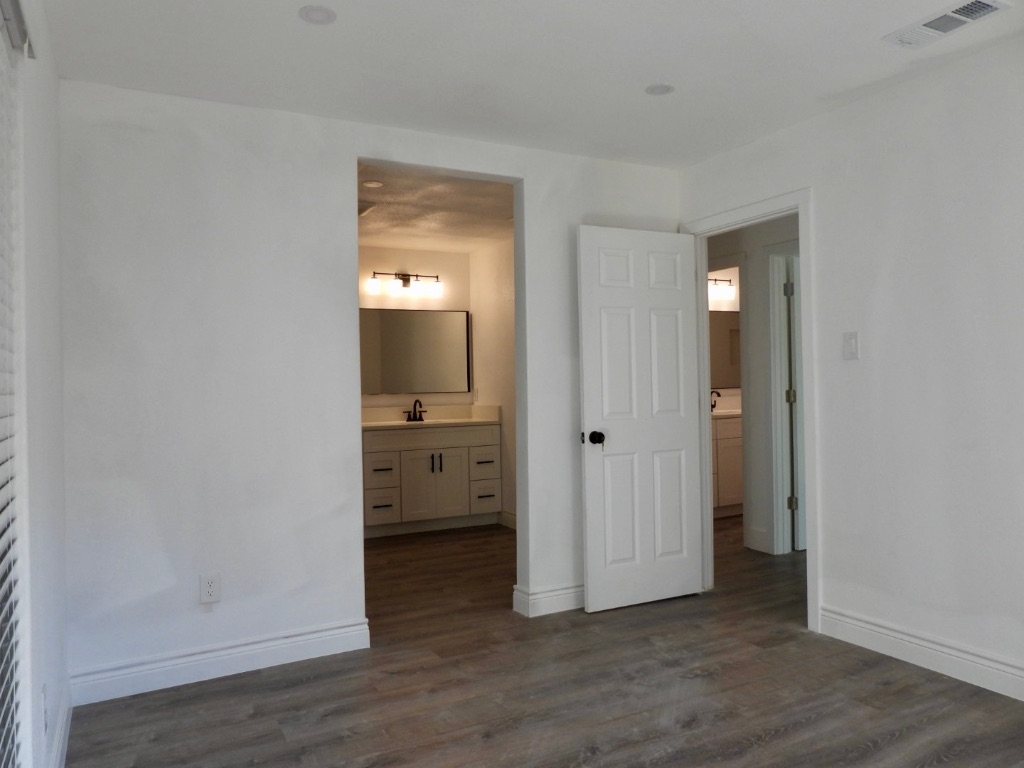 1619 Rutland Drive, Unit A Austin, TX 78758 - Photo 11 of 14 a view of a hallway with a room and wooden floor