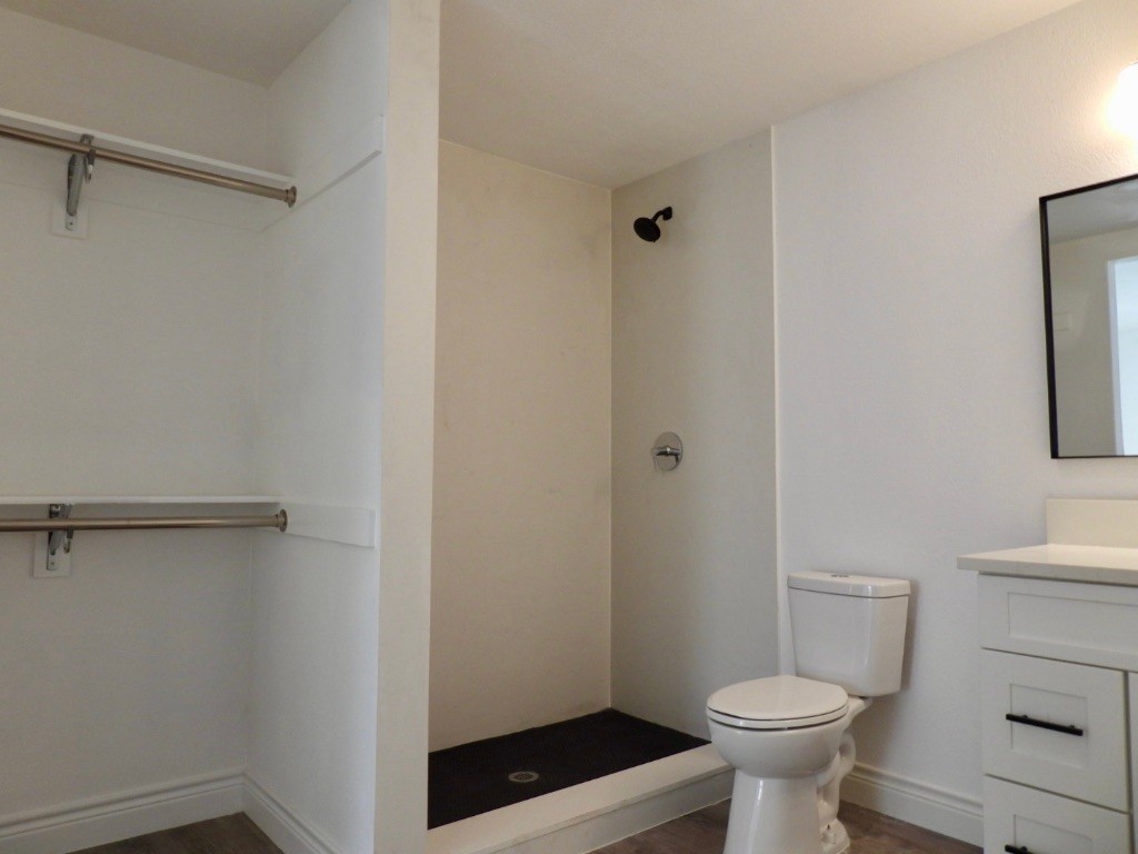 1619 Rutland Drive, Unit A Austin, TX 78758 - Photo 12 of 14 a bathroom with a sink a toilet a shower and a window