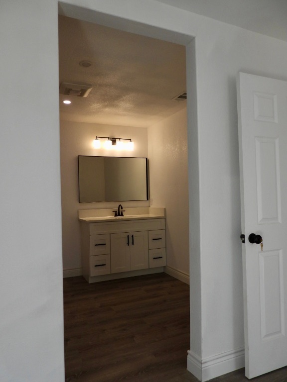 1619 Rutland Drive, Unit A Austin, TX 78758 - Photo 14 of 14 a view of a hallway to room with wooden floor and cabinet