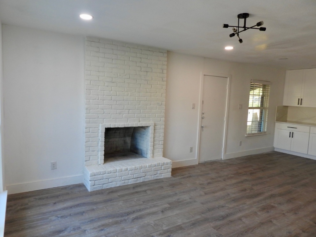 1619 Rutland Drive, Unit A Austin, TX 78758 - Photo 4 of 14 a view of a livingroom with a fireplace and wooden floor
