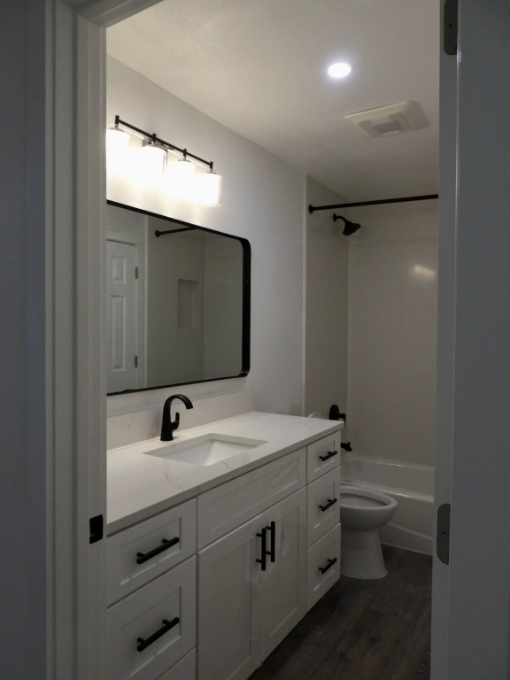 1619 Rutland Drive, Unit A Austin, TX 78758 - Photo 7 of 14 a bathroom with a double vanity sink toilet and mirror